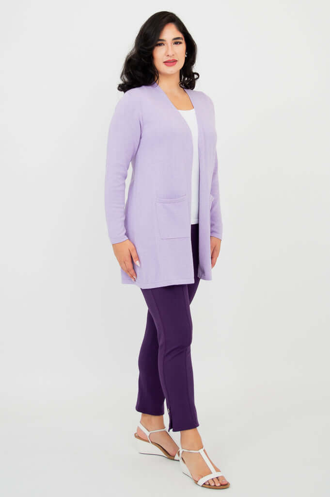 Side view of woman modeling a light purple cardigan sweater paired with purple pants