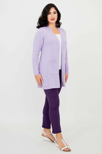 Side view of woman modeling a light purple cardigan sweater paired with purple pants