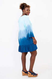 Side view of model in the Ellie Dress, displaying ruffle hem and blue ombre shading