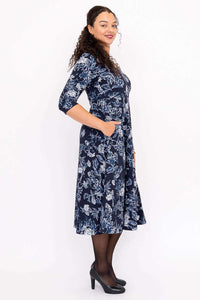 Side view showing pockets of navy floral midi dress with 3/4 sleeves