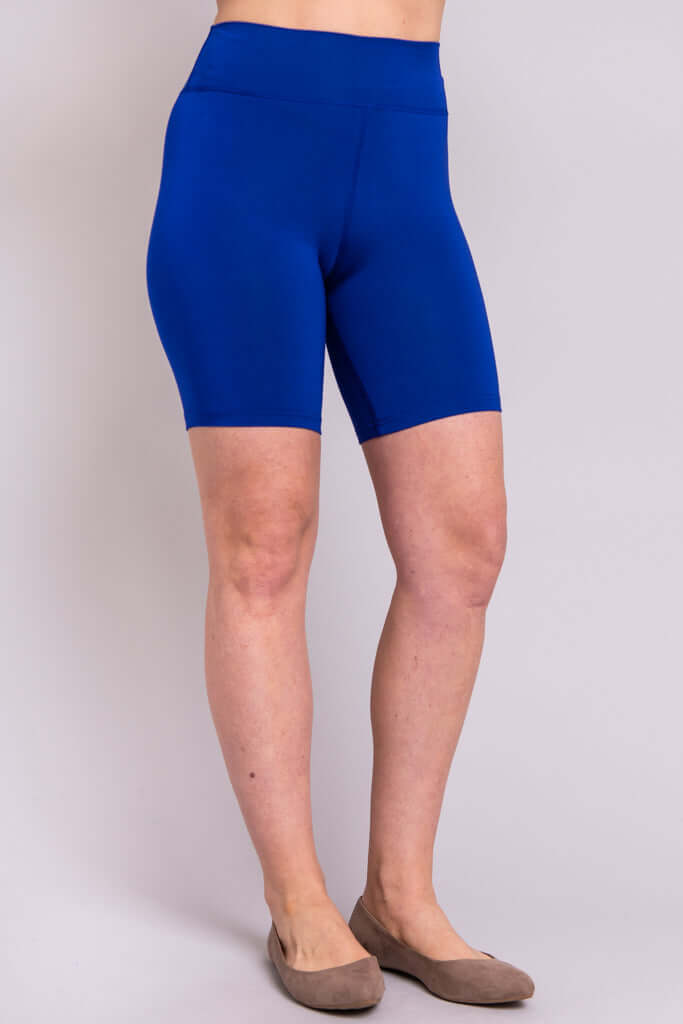Side view of model wearing royal blue bamboo shorts with high waistband