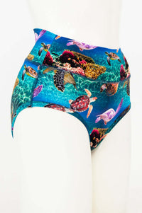 Side view of high-waist brief with vibrant sea turtle and coral reef design