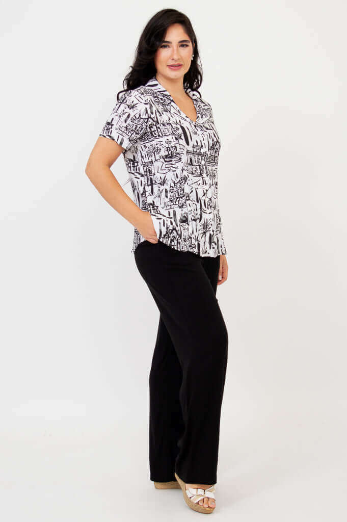Side view of woman in black and white patterned shirt with pockets