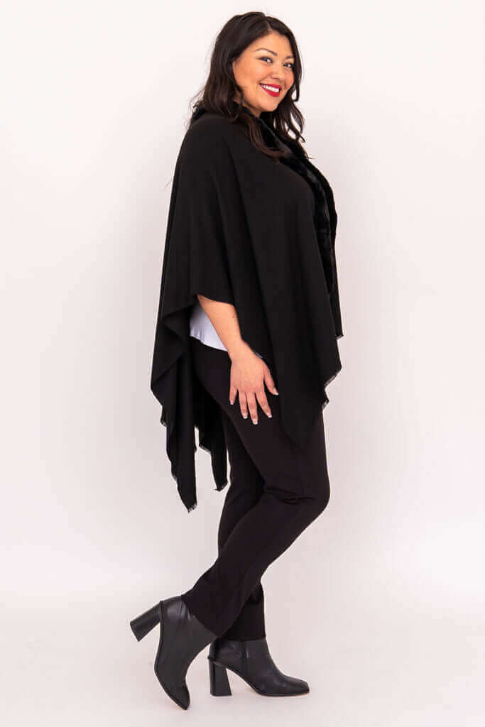 Side view of a woman in a black wrap, smiling