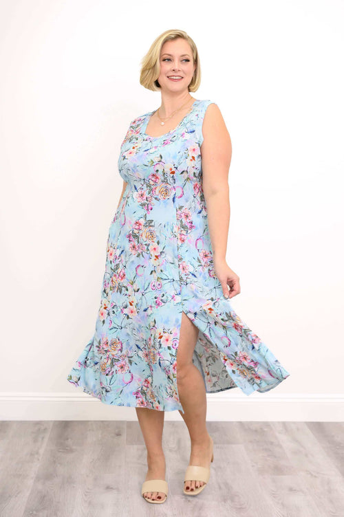 Woman showing side of blue floral midi dress with front slit