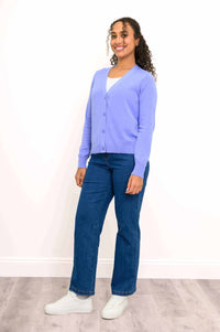 Side view of woman wearing light purple cardigan and blue jeans