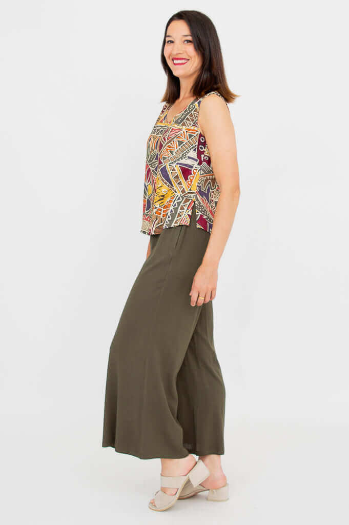 Side view of a woman displaying the profile of a patterned sleeveless tank top