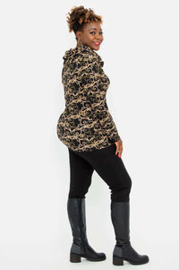 Woman in vine print hooded jacket, side profile view
