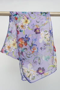 A purple silk scarf with a floral pattern displayed on a rod, front view