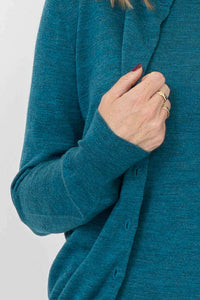 Detailed view of the sleeve and ribbed knit cuff on a soft teal 100% merino wool cardigan.