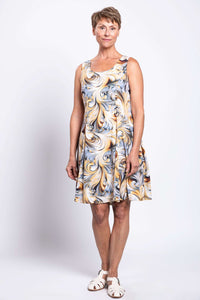 Woman modeling a sleeveless swirl print dress with a scoop neckline