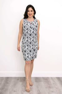 Model wearing sleeveless black and white floral shift dress