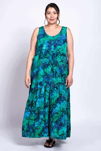 Woman in sleeveless blue and green dress showing relaxed, tiered style, front view