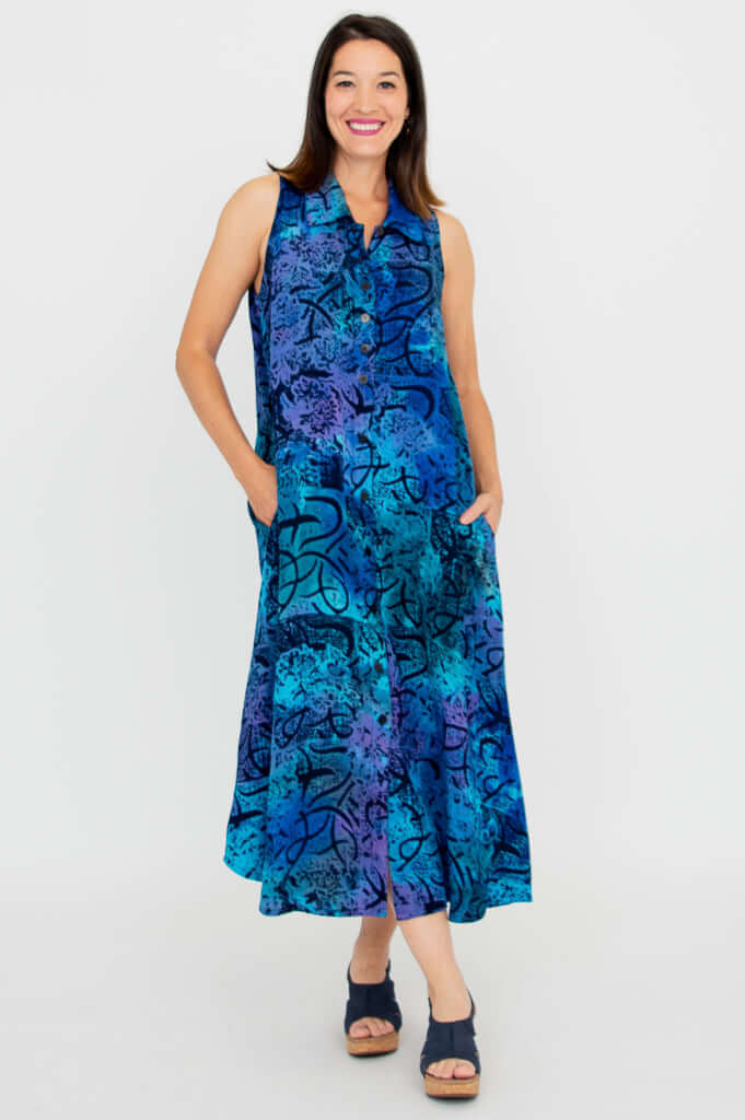 Woman wearing a sleeveless blue and purple A-line dress with collared neckline, facing forward