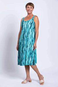 Woman modeling an aqua streak sleeveless dress with an empire waist and A-line skirt