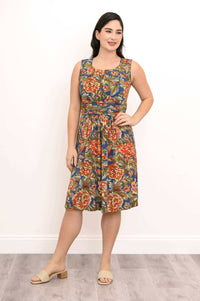 Model in a sleeveless floral dress posing with hand on hip