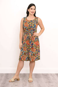 Woman posing with hand on waist in sleeveless floral dress