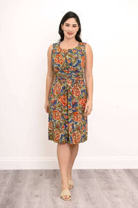 Woman wearing a sleeveless floral dress with ruched bodice and fitted waistband