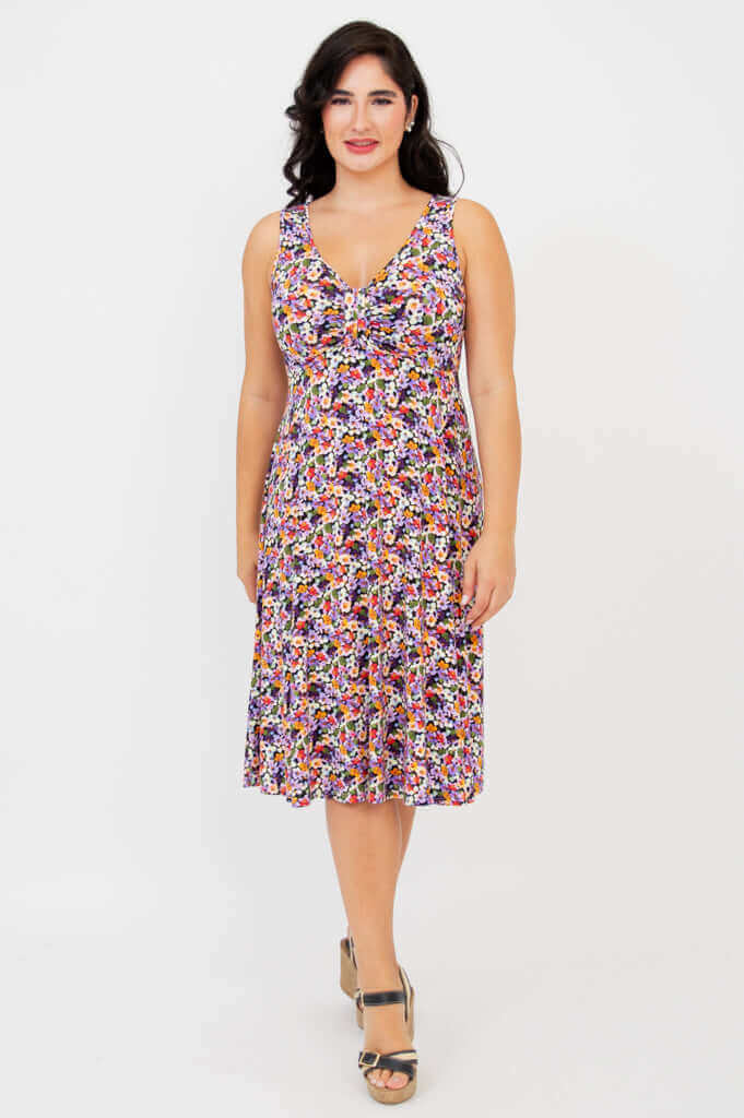 Woman wearing a sleeveless floral fit and flare dress with gathered bust