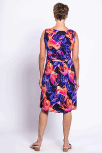 Back view of a woman in a sleeveless multicolored floral swirl dress