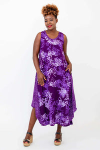 Front pose of woman in sleeveless purple floral midi dress