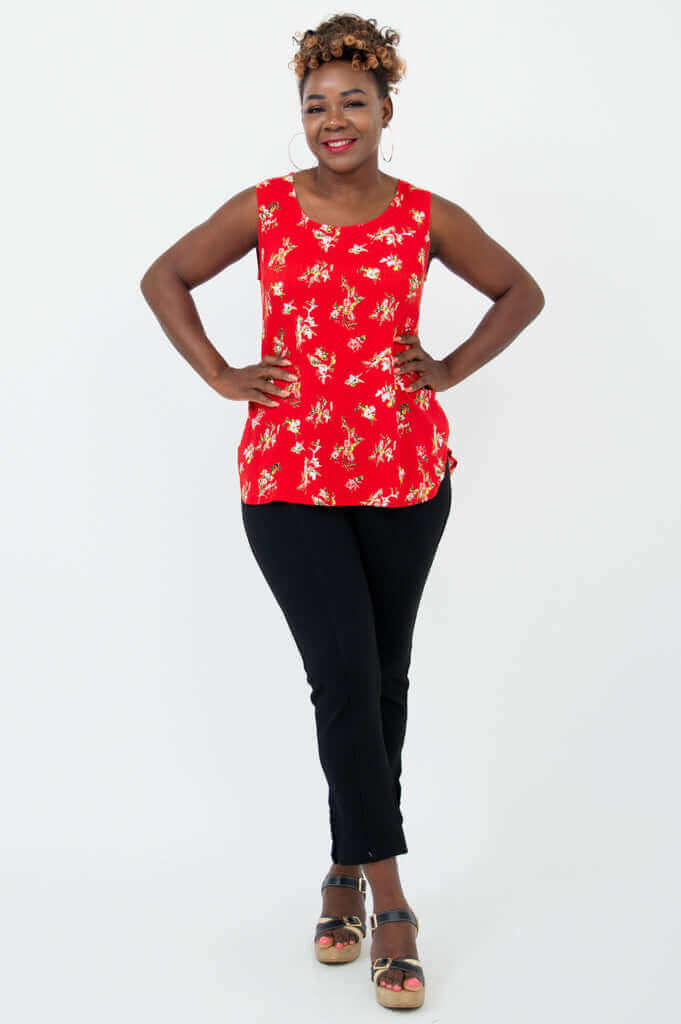 Woman in red floral sleeveless tank top with hands on hips
