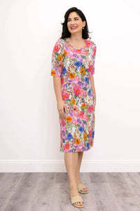 Smiling woman in a knee-length floral bamboo dress with pockets
