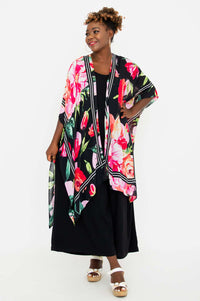 Model smiling in Darcy kimono wrap, highlighted kimono sleeves and draped fit