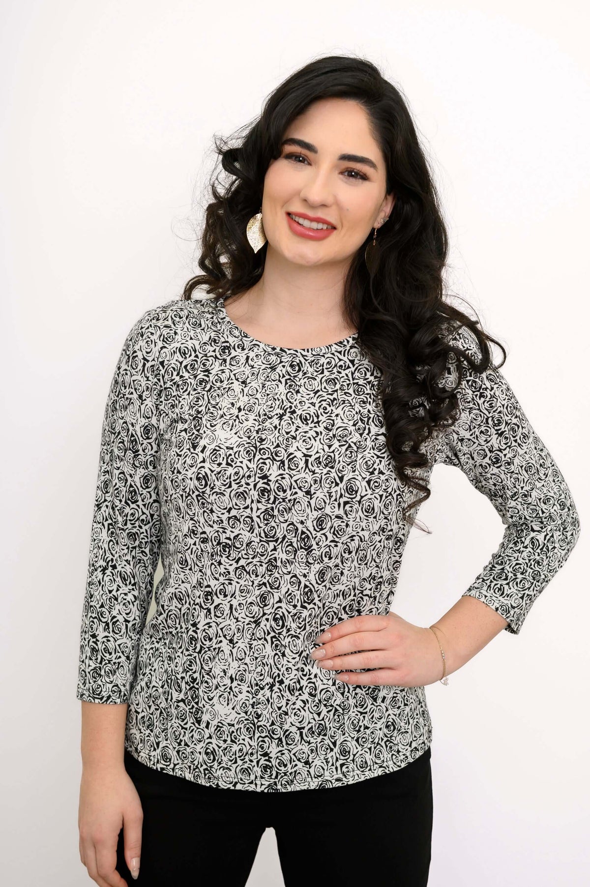 Smiling woman posing in a black-and-white rose print fitted basic tee