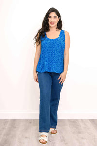 Model wearing blue batik sweetheart top and jeans, smiling at camera