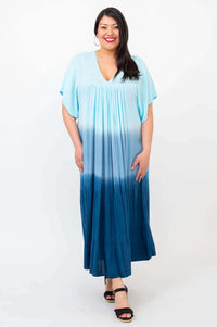Woman smiling in blue ombre tiered maxi dress, facing forward