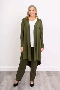 Smiling model in olive green bamboo duster, front view, hands relaxed by sides