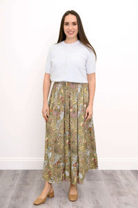 Woman smiling and modeling a floral tiered maxi skirt with a white short-sleeve top