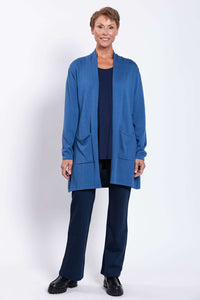 Woman smiling and wearing blue Paige cardigan with open front design
