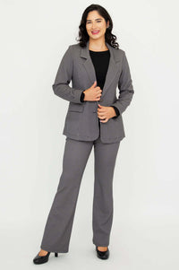 Woman smiling and posing in a fitted checkered blazer and matching pants