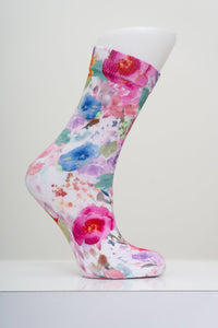 Pink and blue watercolor floral bouquet patterned crew sock shown on a white display mannequin foot form.