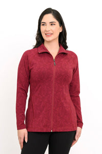 Front view of a women's red geometric print athletic jacket with pockets and a high collar, paired with black pants.