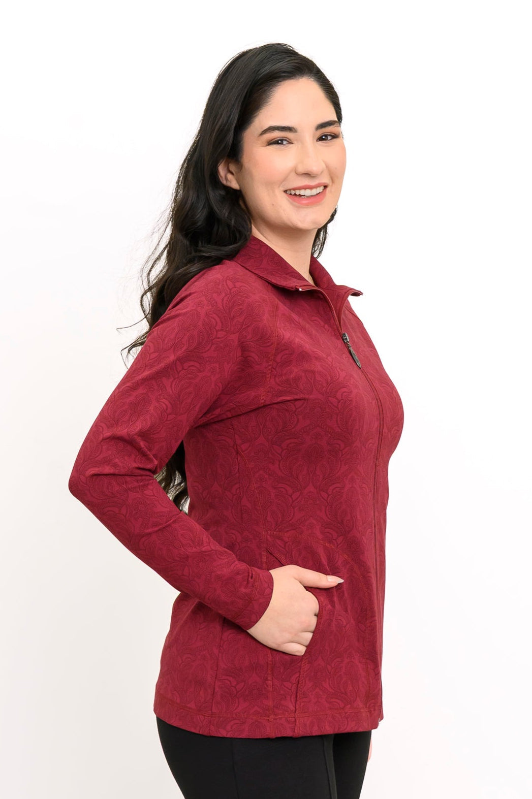 Slightly angled view of a women's red patterned mock neck jacket, showcasing a comfortable, body-skimming fit.