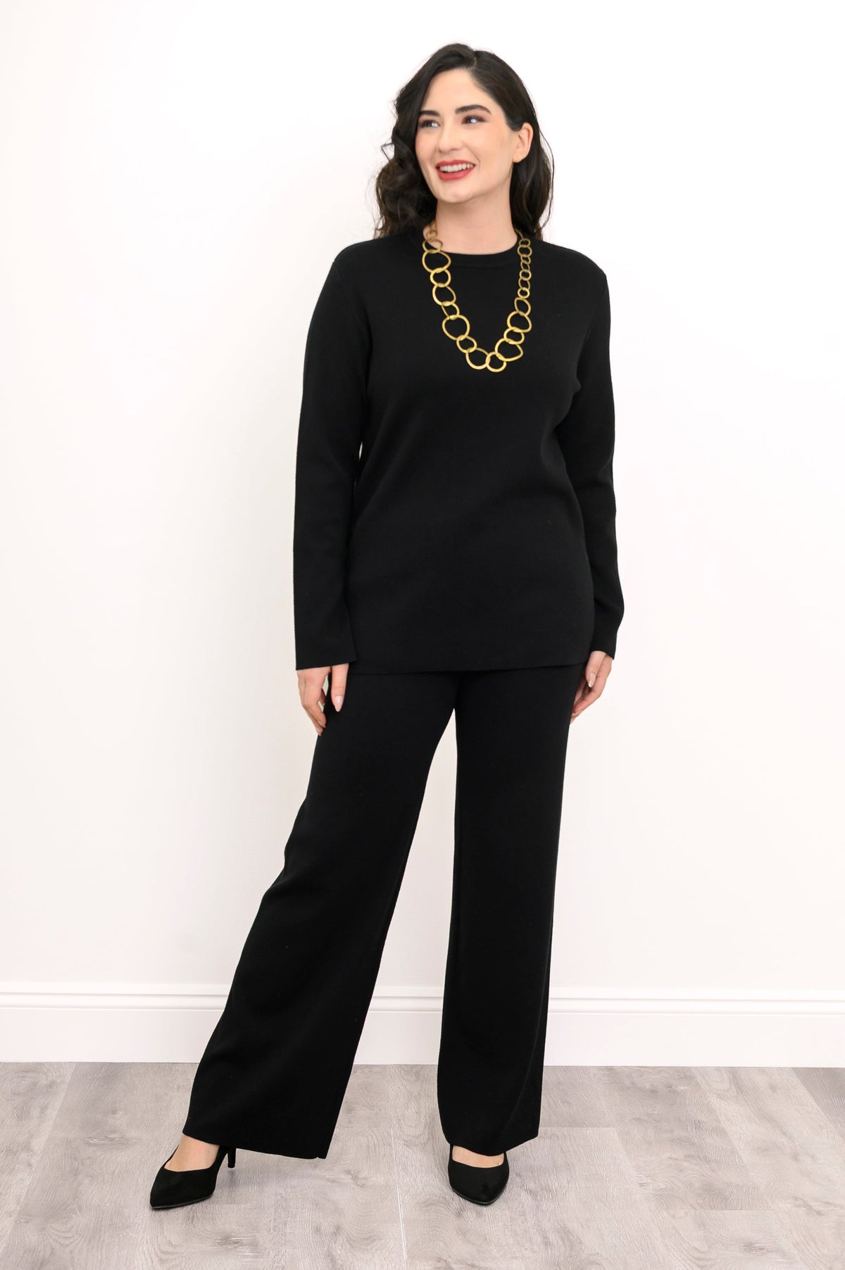 Front view of a women's ebony pullover sweater paired with comfortable fluid lounge pants, relaxed silhouette.