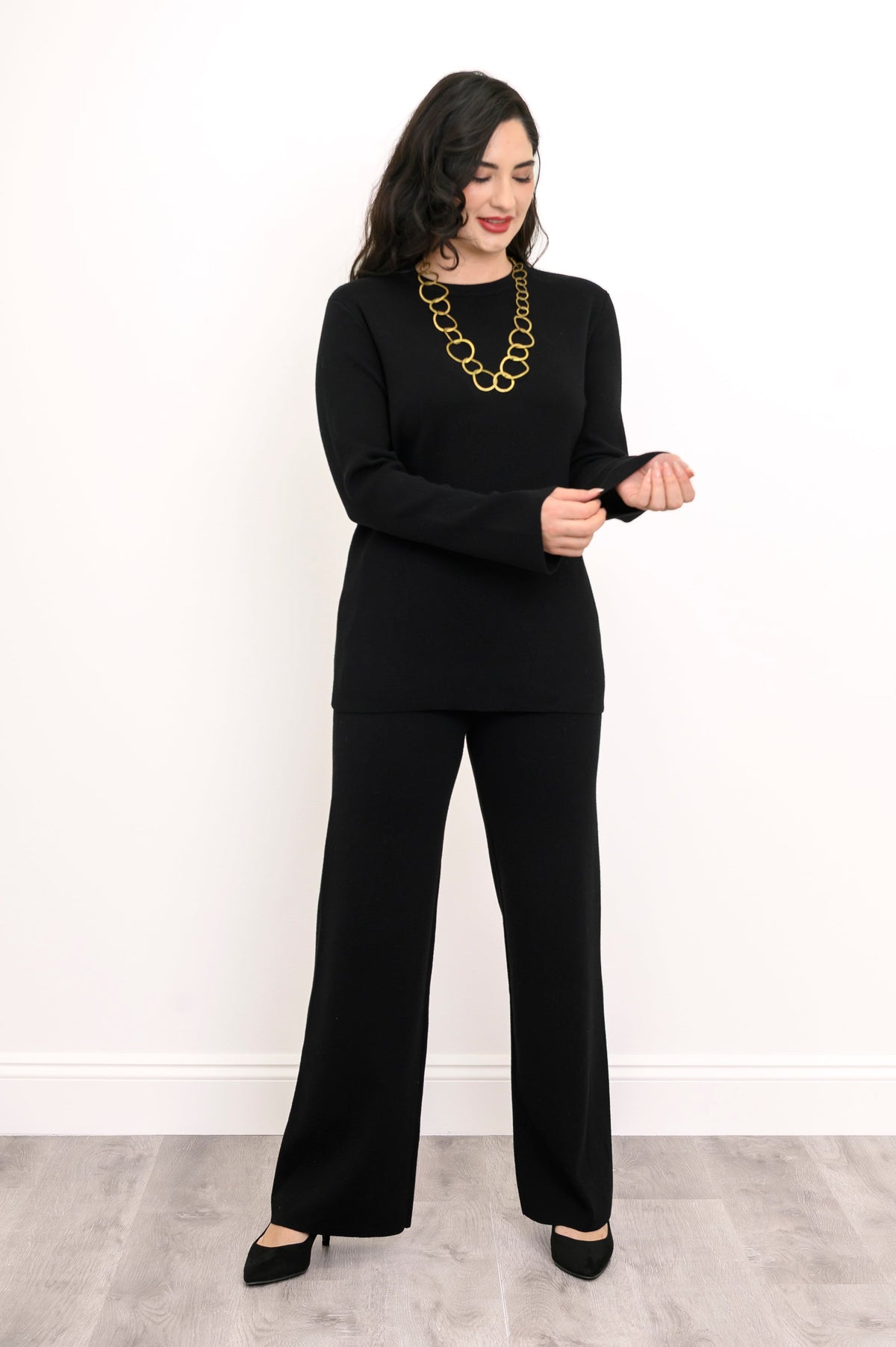 Front view of a women's ebony-colored rectangular knit top, showing a comfortable, loose-fitting drape.