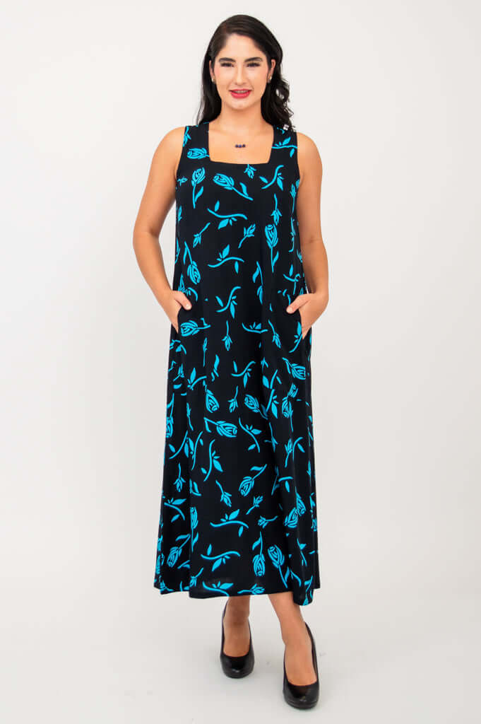 Woman wearing long black dress with blue floral print and square neckline