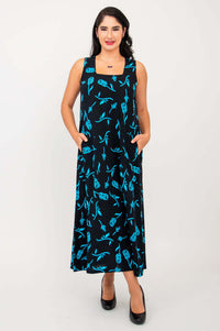 Woman wearing long black dress with blue floral print and square neckline