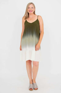 Woman standing in olive ombre dress, hands at sides