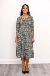 Straight front shot of an everyday grey floral print dress with a scoop neck and three-quarter sleeves.