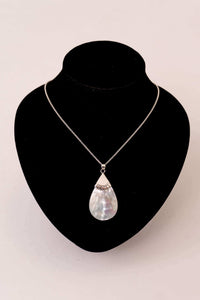 Sterling silver teardrop pendant necklace displayed on a black velvet bust
