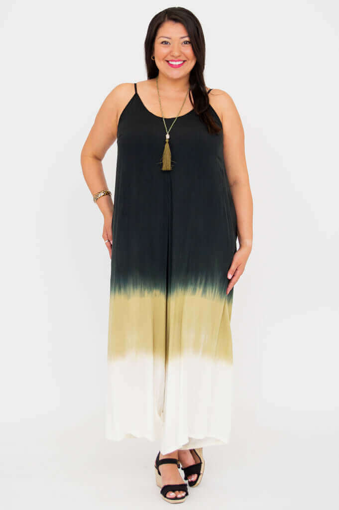 Straight-on view of a woman in a flowy ombre jumpsuit with v-neckline and adjustable straps