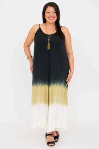 Straight-on view of a woman in a flowy ombre jumpsuit with v-neckline and adjustable straps