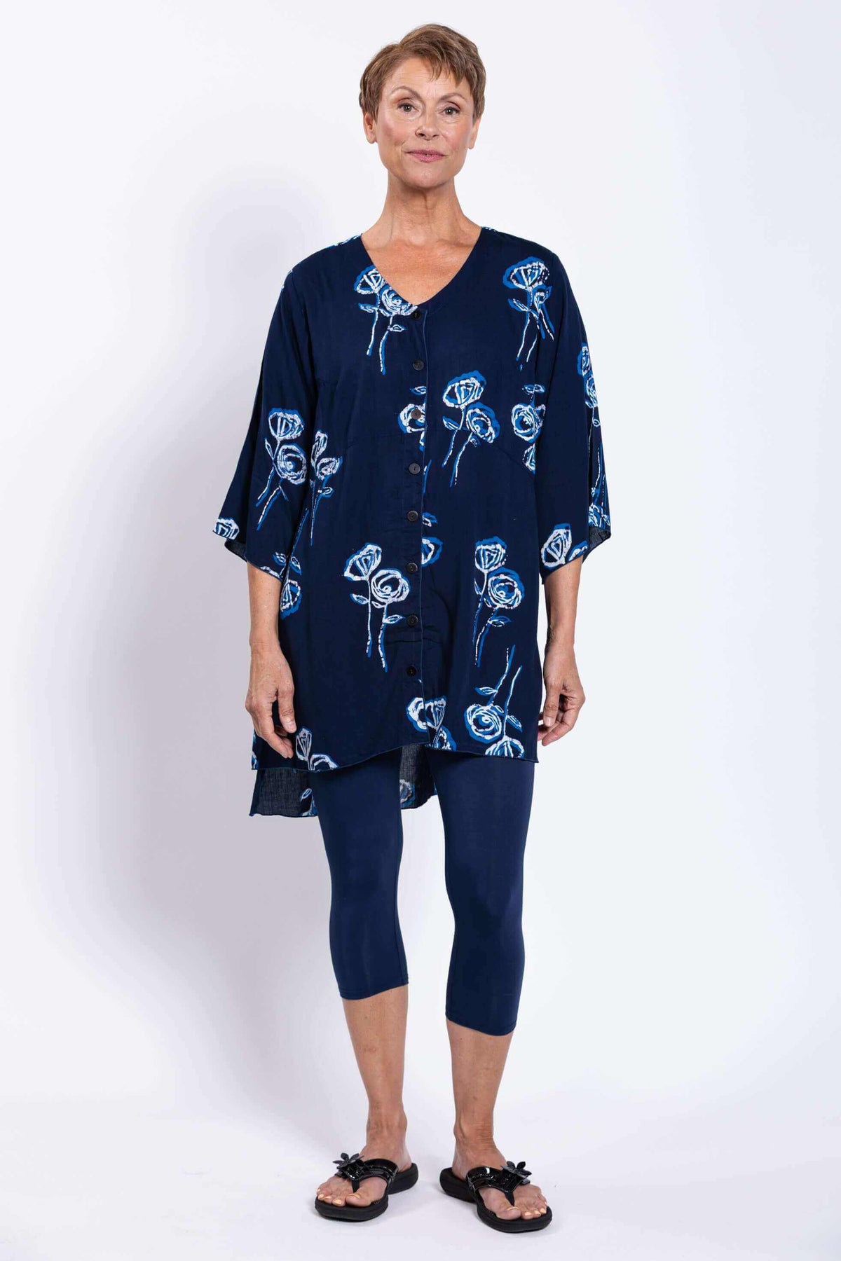 Straight front view of woman modeling navy blue Darla blouse with floral print