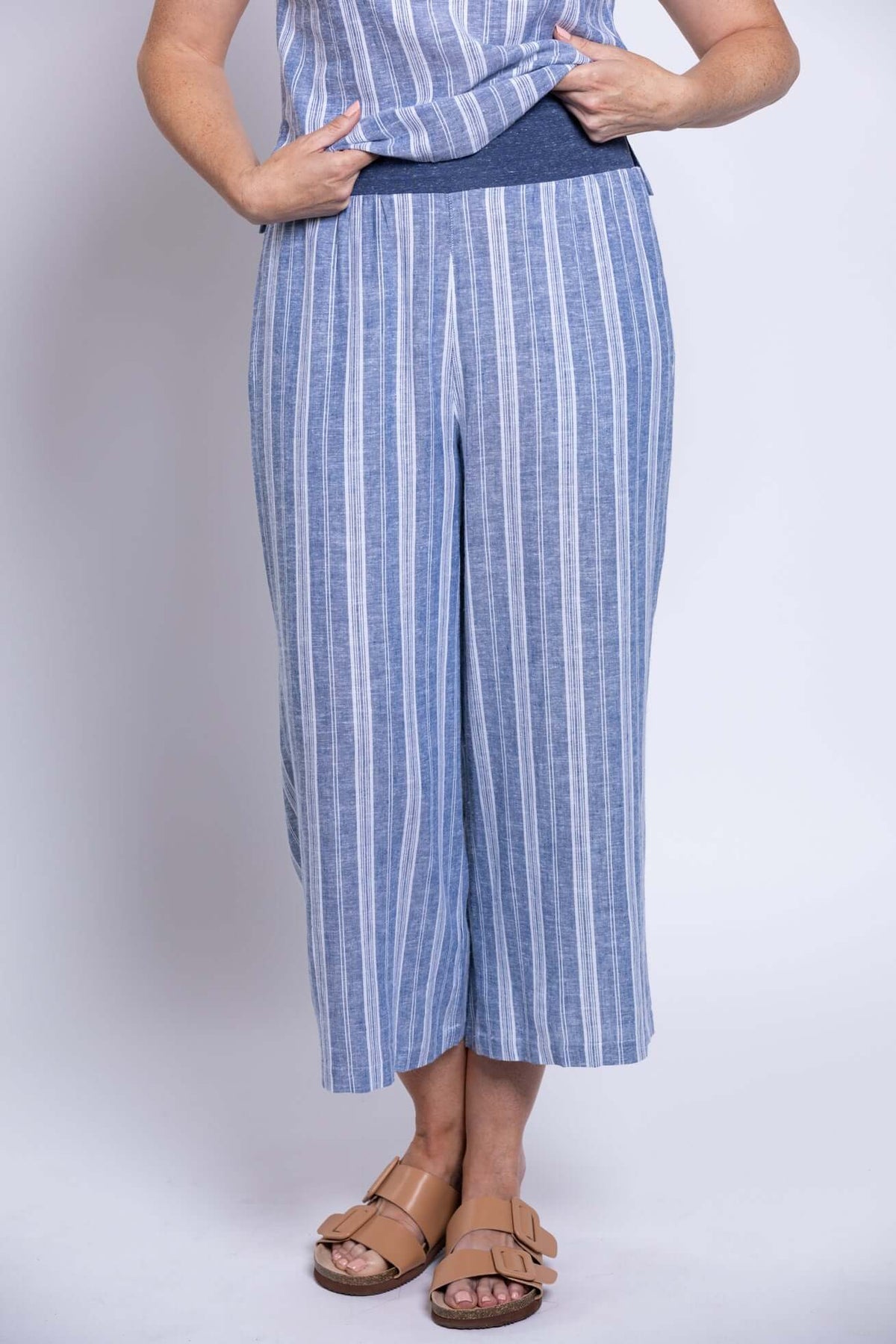 Close-up of striped blue cropped capri pants with wide-leg style and pull-on waistband