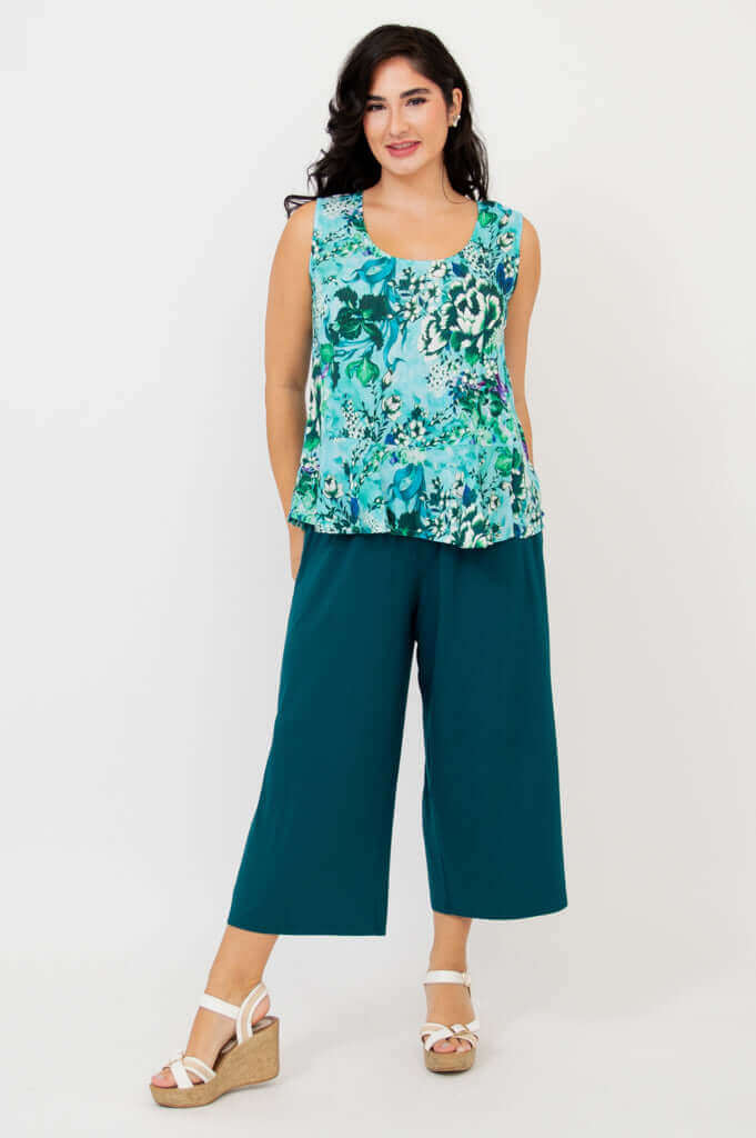 Full body view showing Ginny Tank styled with teal wide-leg pants and white sandals